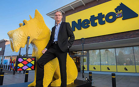 Chief executive of Netto's parent company, Dansk Supermarked, with Bright Bricks' dog made from Lego Photo: Paul Cooper